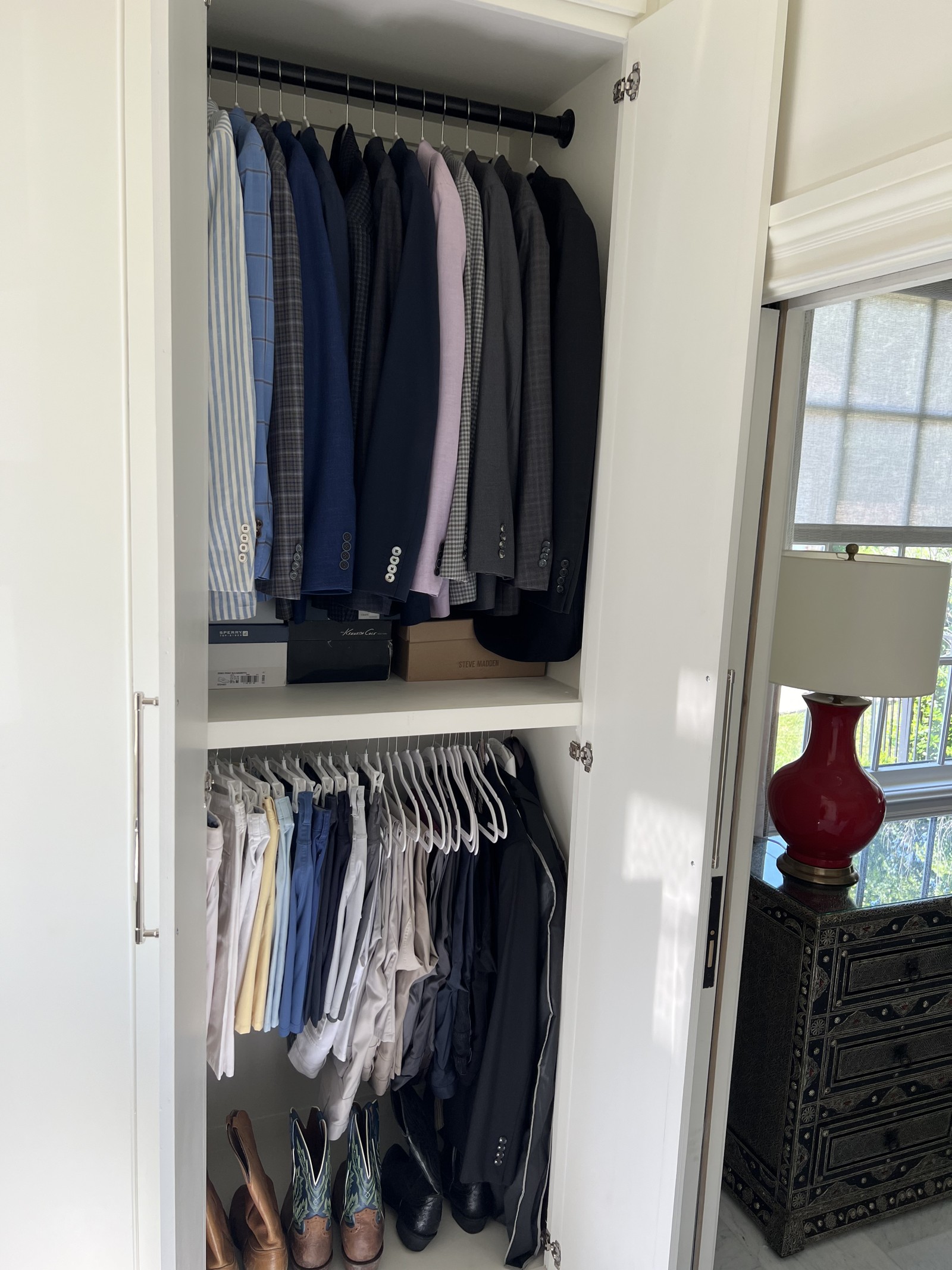 Main closet reveal of business and bottoms