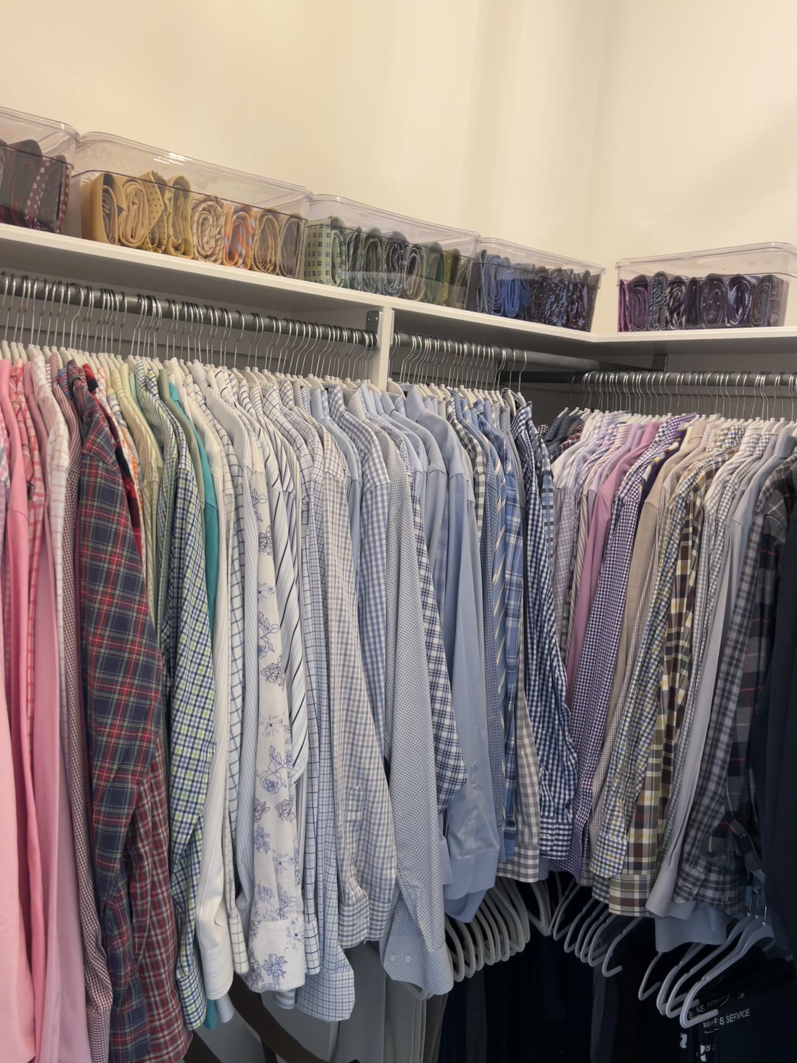 Organized closet with clothing arranged by category