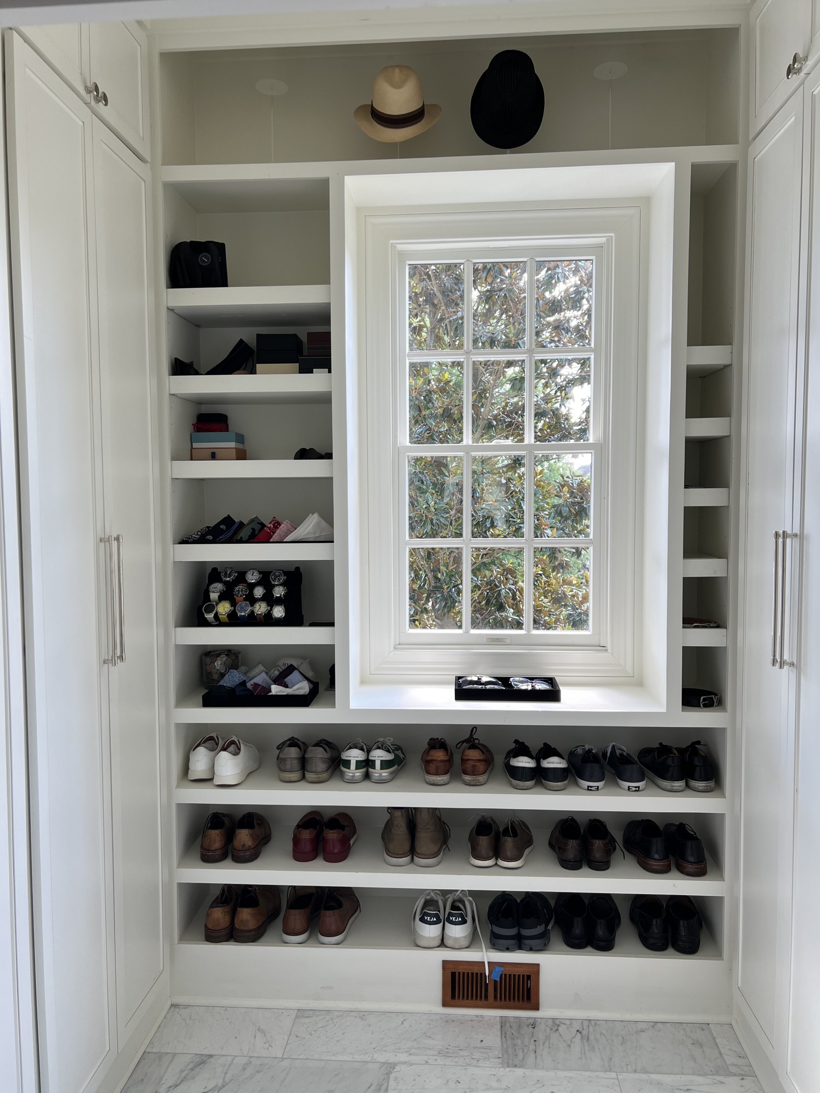 The same Franklin master closet after organizing, with everyday clothing hung, contained, and easy to see